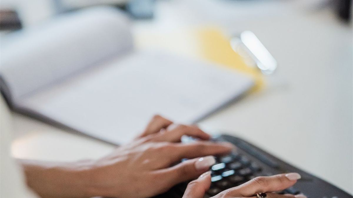 Mains tapant sur un clavier d'ordinateur